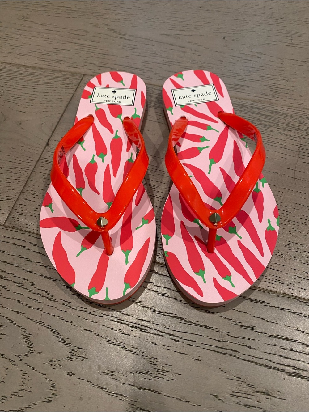 kate spade pink flip flops with red pepper print